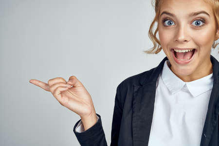 happy girl with curly hair indicates something.の写真素材