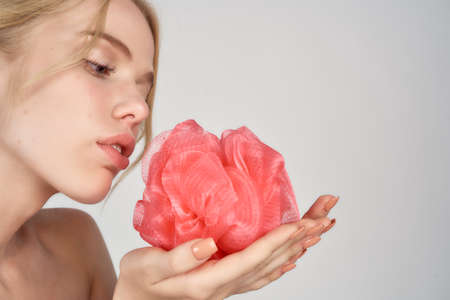 woman holding a loofah in her hands closeup.