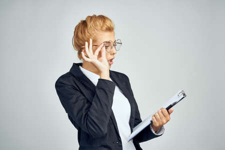 business girl with glasses examines documents and is surprised.の写真素材