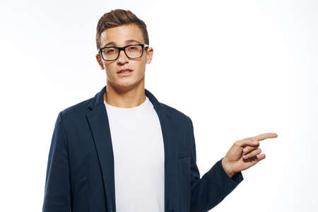 man in a jacket points with his hand to the side on a white background.の写真素材