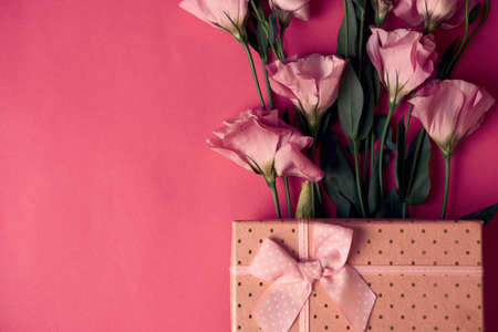flowers and gift on pink backgroundの写真素材