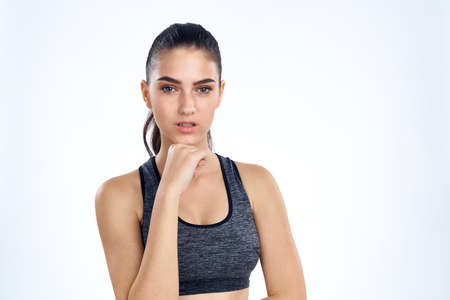 sporty girl with hand at face.の写真素材