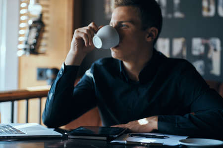 business man drinking coffee in cafe.の写真素材