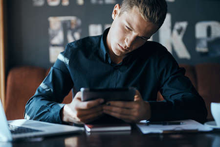 man carefully studying the tablet.の写真素材