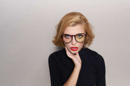 blonde with glasses, hand, light background.の写真素材