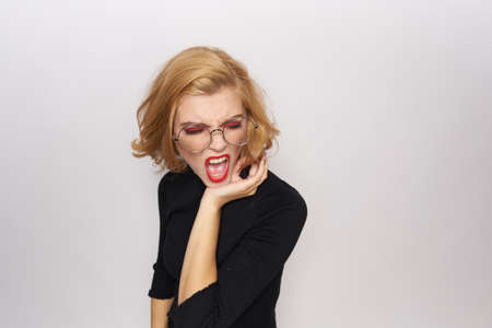 Blonde with glasses is angry, a lot of free space to copy.の写真素材