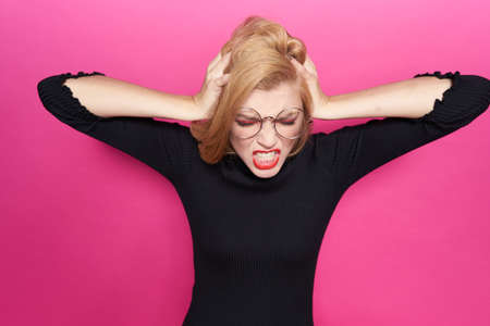 The blond in glasses or spots seizes for a head and is angry.の写真素材