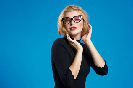 beautiful woman in glasses holds hands at face.の写真素材