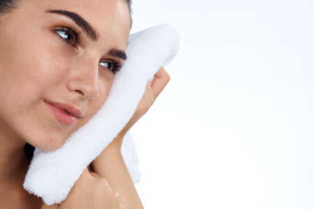 Girl with a towel by her cheek.の写真素材