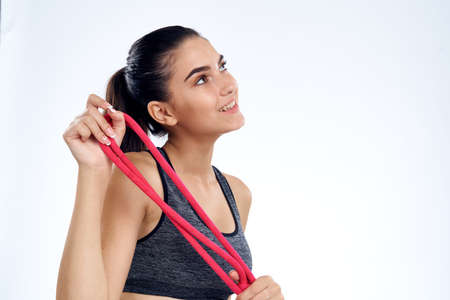 sporty girl with ropes in hands smiling.の写真素材