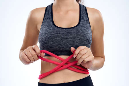 athletic girl with ropes around her belly.の写真素材