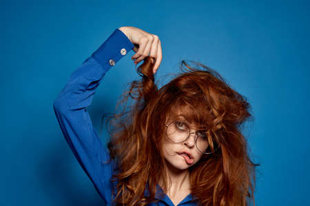 shaggy girl with glasses and a blue shirt is fooled.の写真素材