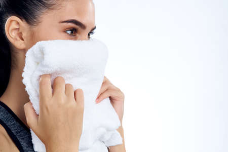 girl with a towel by the face.の写真素材