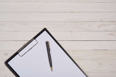 wooden background, tablet, pen.の写真素材