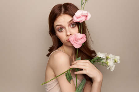 beautiful girl covers her face with flowers.の写真素材