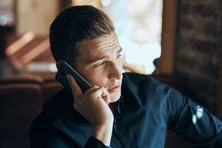 man talking on the phone and looking away.の写真素材