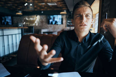 man in black shirt shows direction.の写真素材