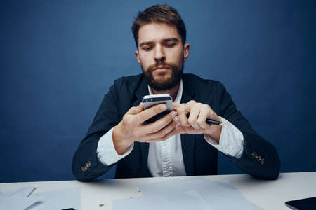 Business man holding a phone.