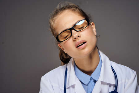 girl doctor wearing glasses tired.の写真素材
