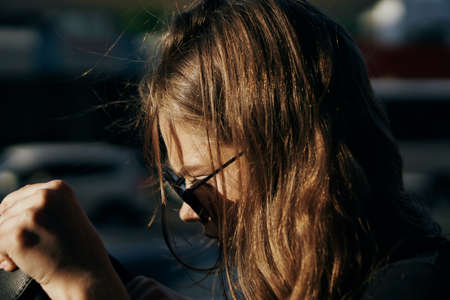 Beautiful young woman walking outdoors in summer in the city, nature, megalopolis, fashion, style.の写真素材