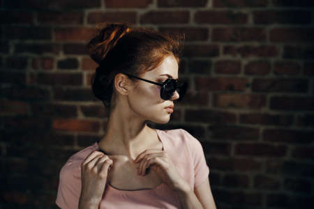 portrait of a beautiful girl near a brick wall.の写真素材