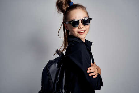 young stylish girl in black clothes and glasses.の写真素材