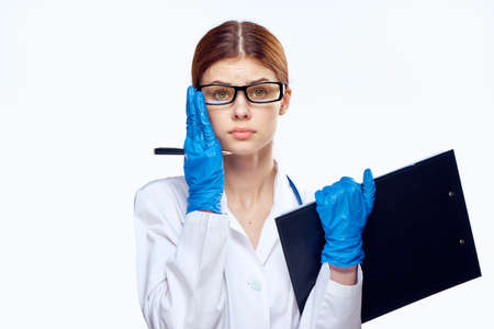 woman doctor, folder, pen, gloves.の写真素材