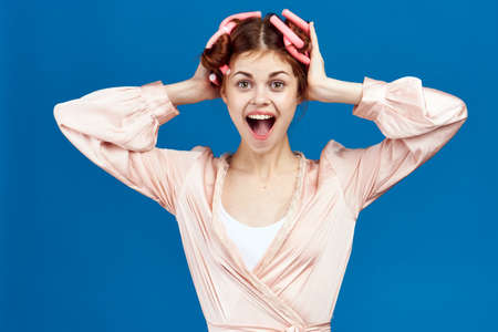 housewife, pink robe, hair curlers.の写真素材