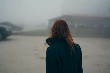 girl in a dark cloak on a gloomy background.の写真素材