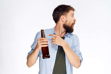 man shows on beer on white isolated background.の写真素材