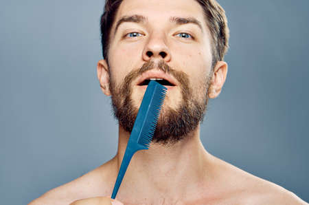 man with a beard, comb, close-up, personal care.