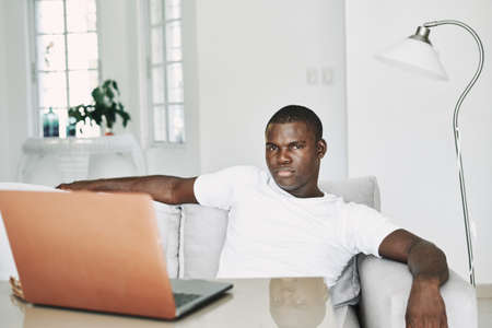 Male african  freelancer with laptop at home model