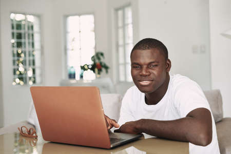 Male african  freelancer with laptopの写真素材