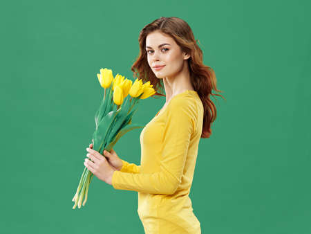 beautiful woman yellow flowers bouquetの写真素材