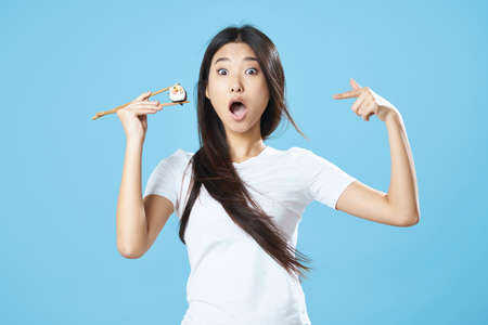 A woman of Asian appearance sushi rollsの写真素材