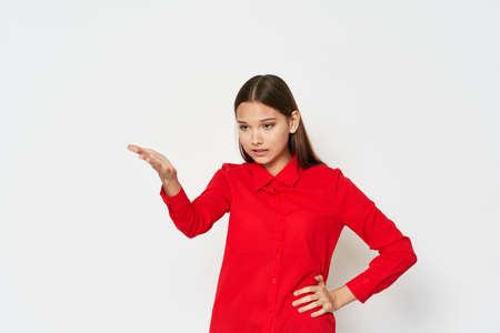 Woman in red shirt gesticulating with hands cropped view model girlの写真素材