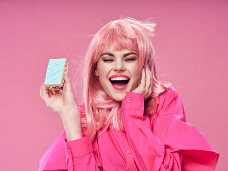 Cheerful woman pink hair cake emotion model