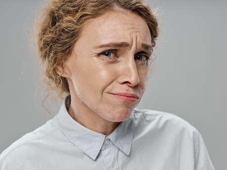 woman perplexedly looks at the camera on an isolated background model