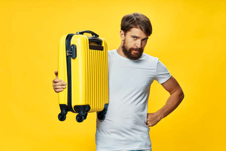 Man with yellow suitcase vacation travel passengerの写真素材