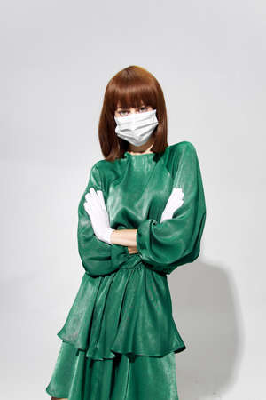 Fashion female coronavirus, model posing with gloves and protective medical mask
