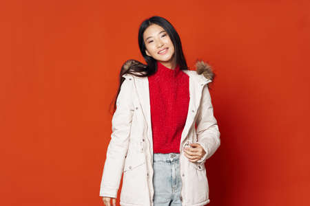 A happy woman with narrow eyes is smiling at the cameraの写真素材