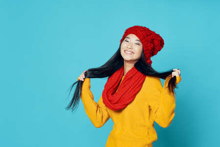 Happy woman touches her hair with her hands and laughs at the cameraの写真素材