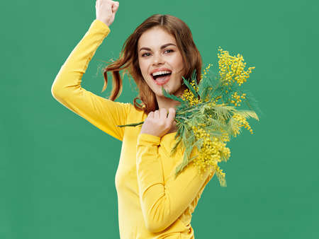 Charming woman with yellow spring flowers Model cropped viewの写真素材
