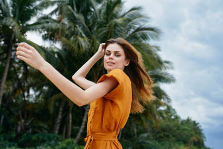 delightful woman in a sundress has a rest on the nature on the island