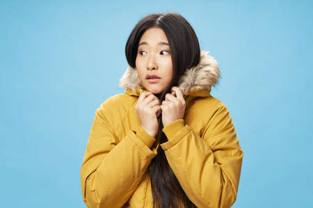 A girl of Asian appearance looks away
