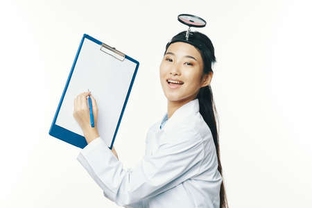 Doctor woman with medical instruments on her head and documentsの写真素材