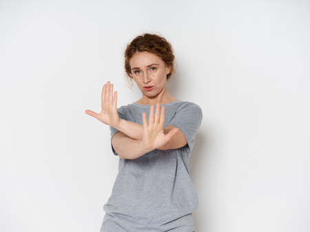 Elderly woman shows negative gesture with handsの写真素材