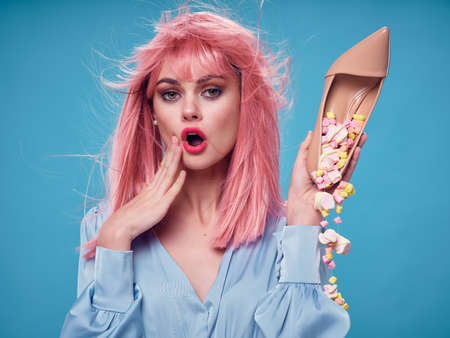 Woman holding in hands buy sweets marshmallows pink hair dessert