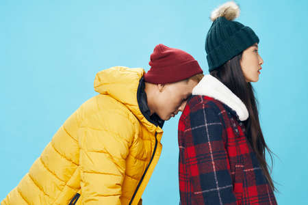 a tired guy in warm clothes leaned on the back of a womanの写真素材