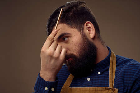a man with a comb looks after the appearance of a hairdressing